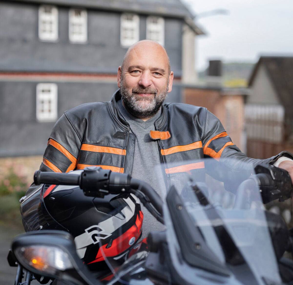 Portrait photo of Michael sitting on his motorbike. Michael lives with MS and lives with bladder issues. He found that his bladder was overactive and he had to void his bladder more often than other people. 